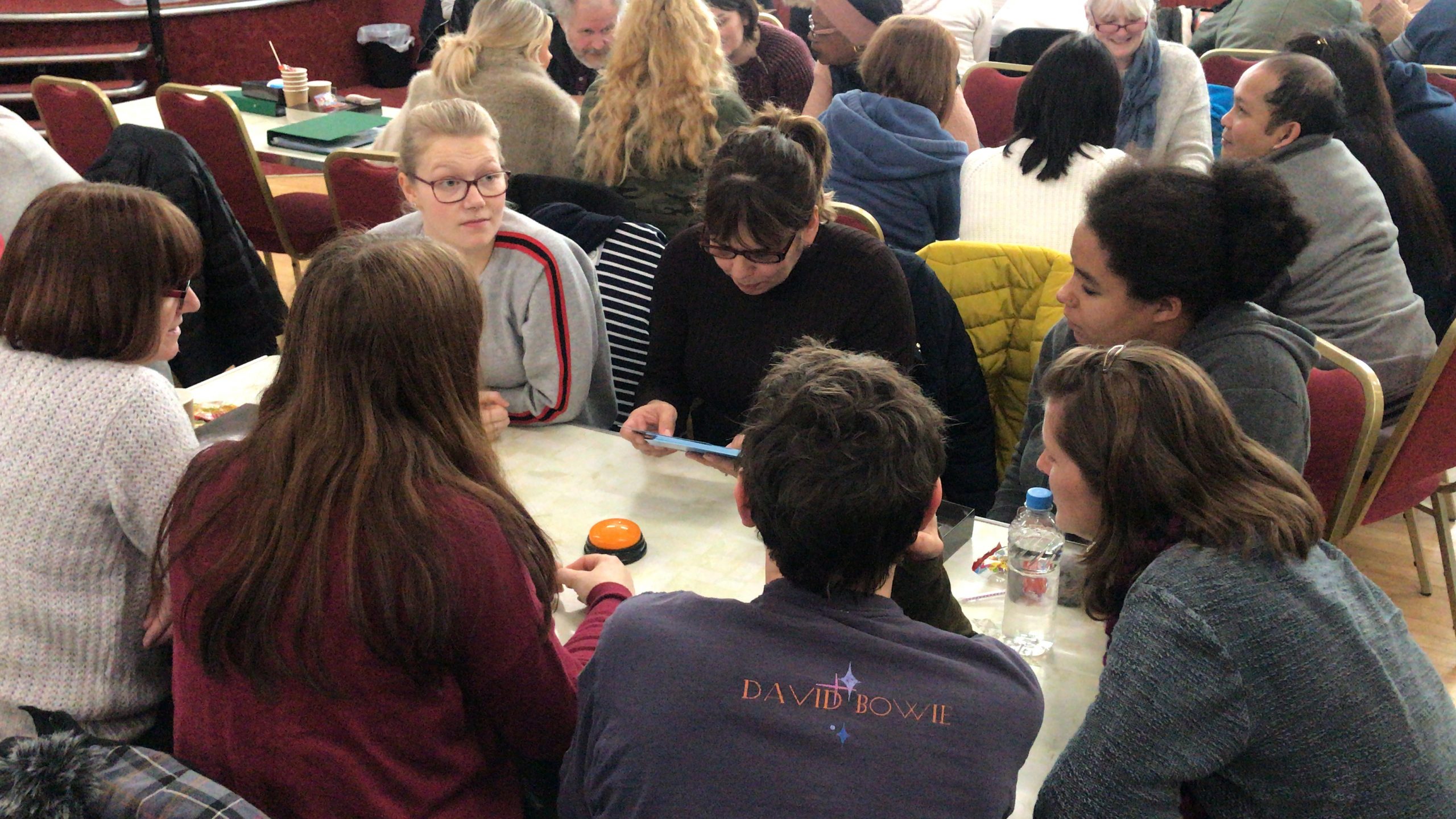 a group of people around table focused on a task