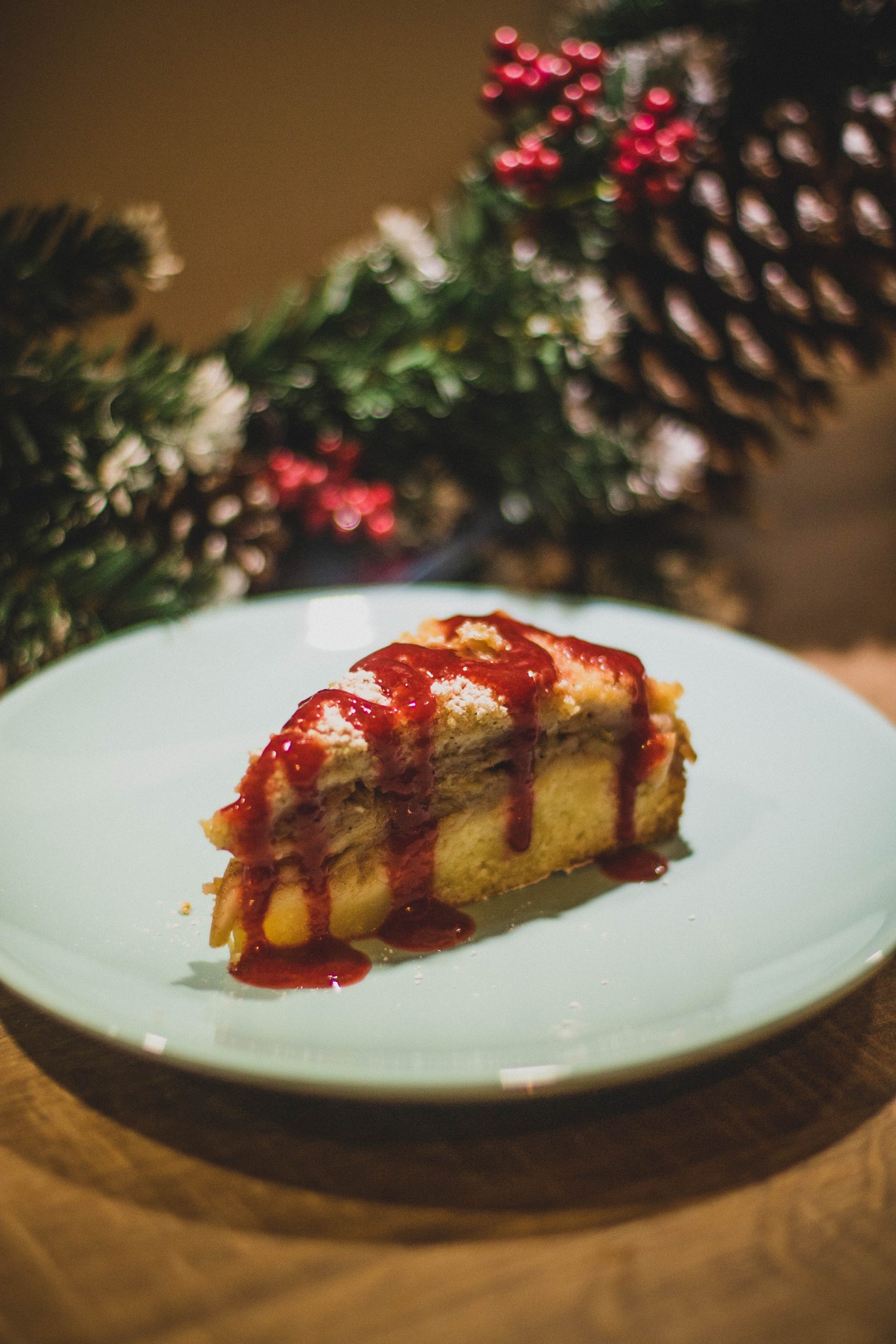 a plate with a cake on with Christmas decoration in the back