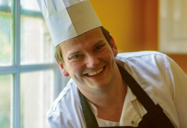 a young chef smilling at the camera