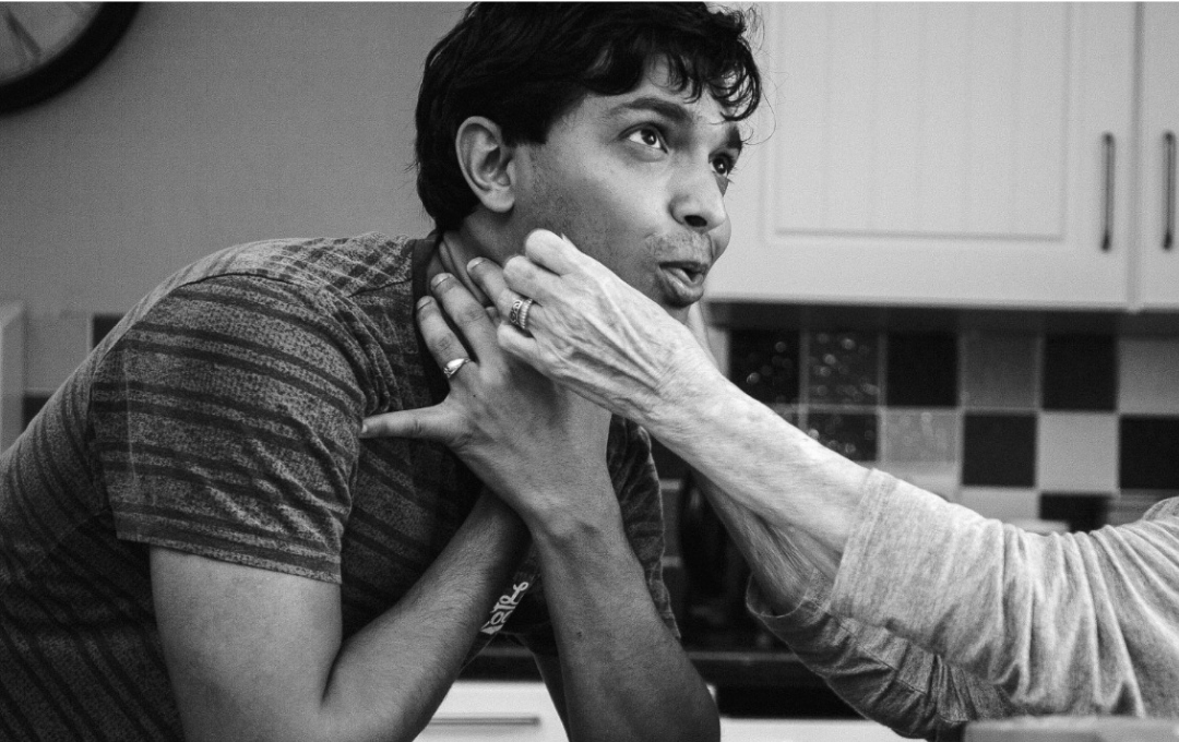 a black and white image of a woman pretending to be choked