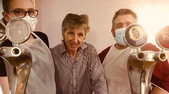 an elderly lady with two other people wearing face masks