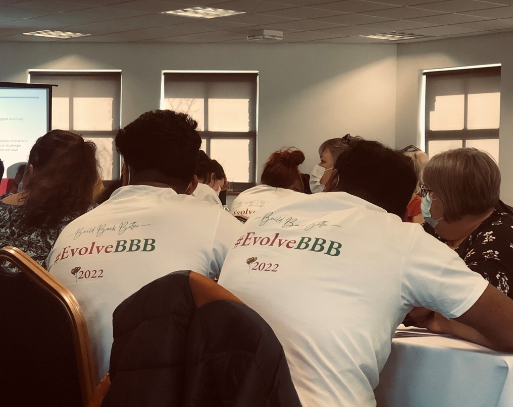 two men wearing an evolve BBB shirt
