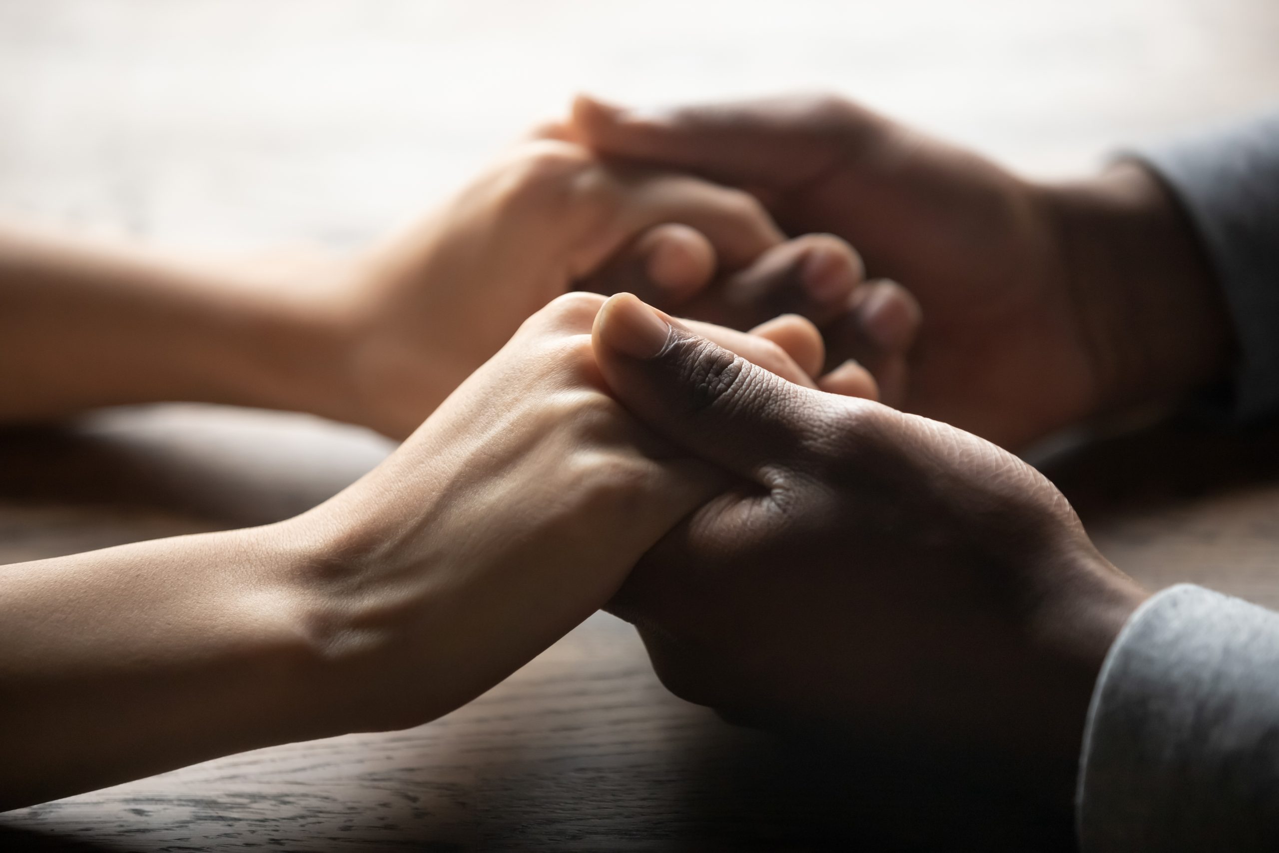 a close up of two people holding hands